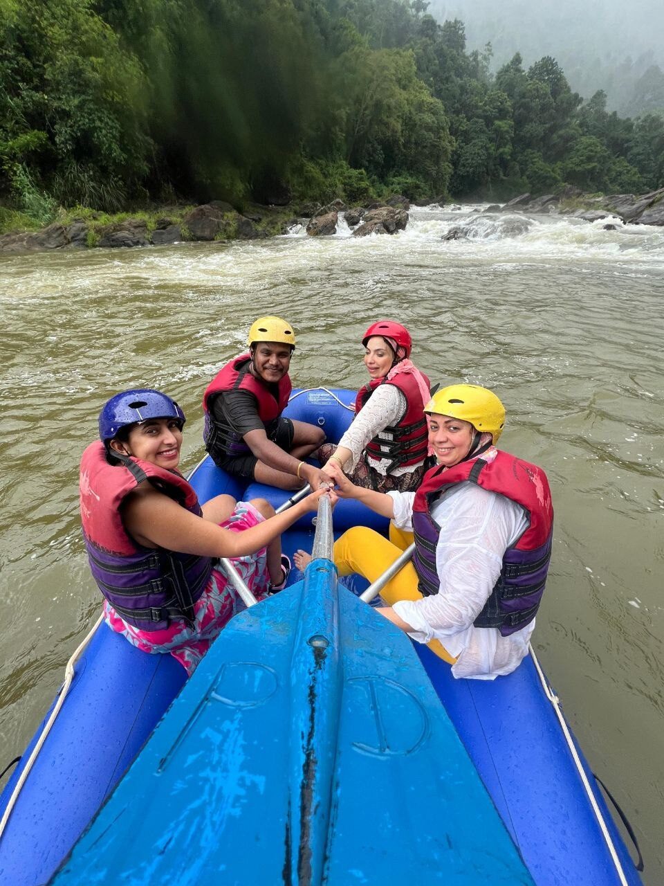 Travellers white-water rafting together on a Sri Lankan river