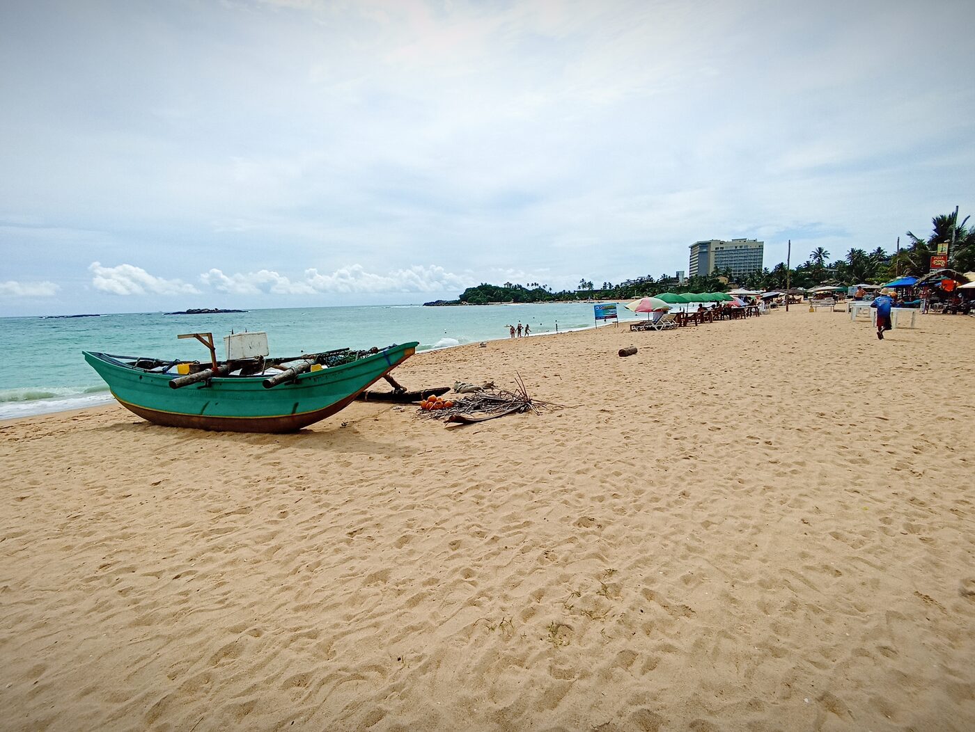 Traditional wooden fishing boat resting on a tropical Sri Lankan beach